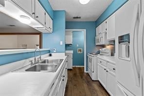 kitchen with white cabinetry, white appliances, dark wood-type flooring, and sink