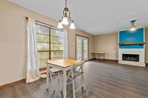 dining room featuring a fireplace and dark hardwood / wood-style floors