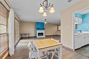 dining room featuring sink, hardwood / wood-style floors, and a chandelier