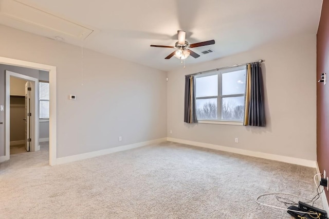 carpeted spare room with ceiling fan