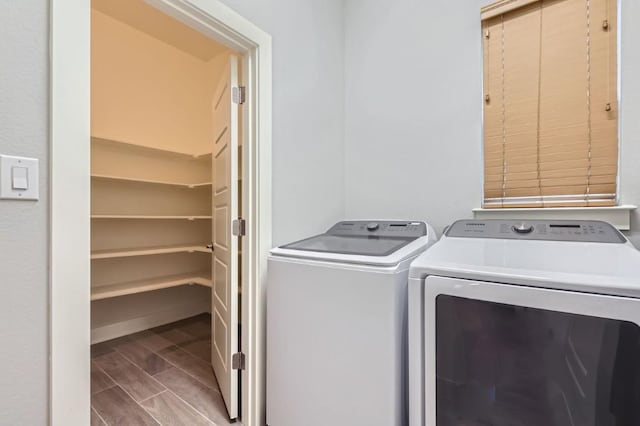 clothes washing area with separate washer and dryer