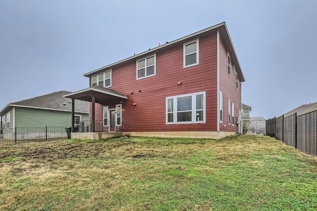 back of house with a yard