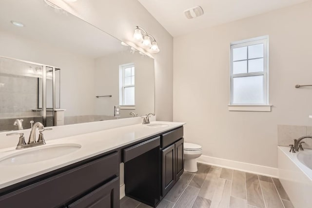 full bathroom featuring vanity, toilet, separate shower and tub, and hardwood / wood-style floors