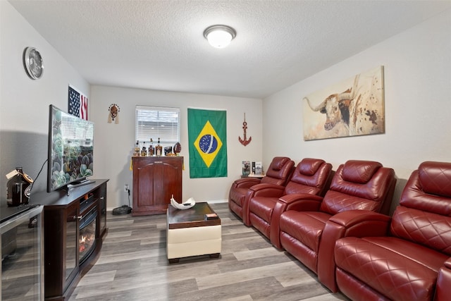 interior space featuring hardwood / wood-style flooring, beverage cooler, and a textured ceiling