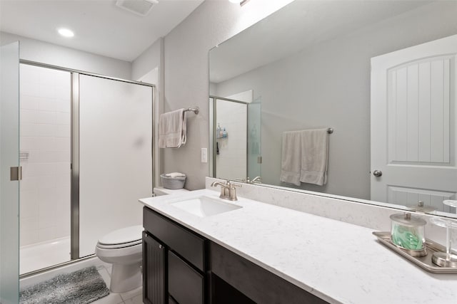 bathroom featuring vanity, toilet, and walk in shower