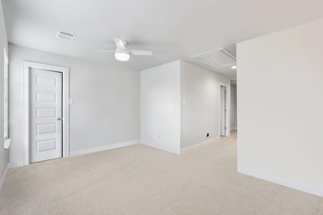 empty room with ceiling fan and light carpet