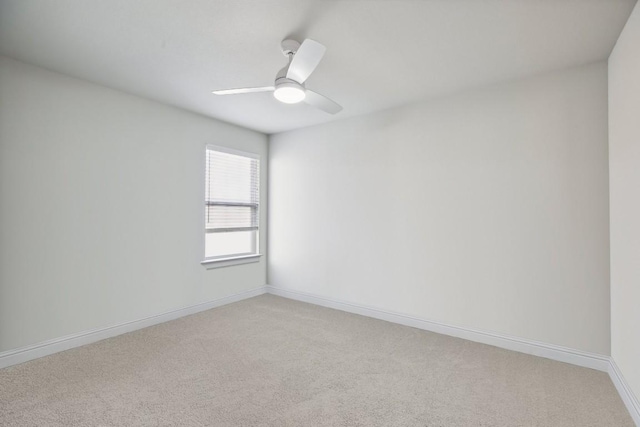 empty room featuring ceiling fan and light carpet