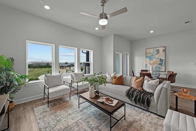 living room featuring hardwood / wood-style flooring and ceiling fan