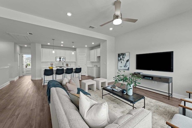 living room featuring ceiling fan and light wood-type flooring