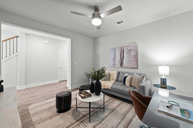 living room with hardwood / wood-style flooring and ceiling fan