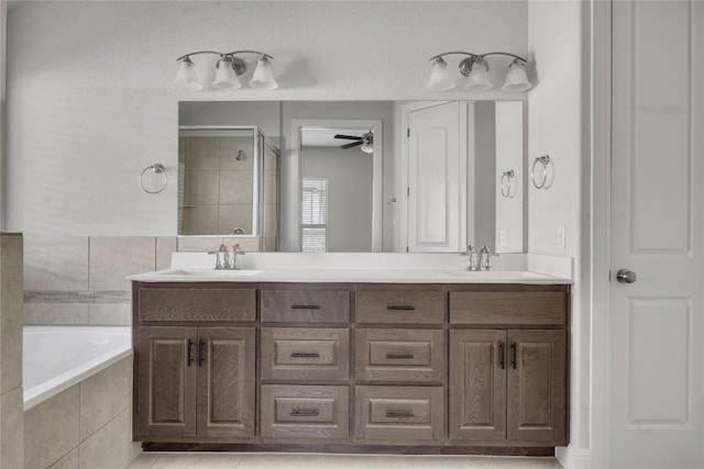 bathroom featuring vanity, independent shower and bath, and ceiling fan