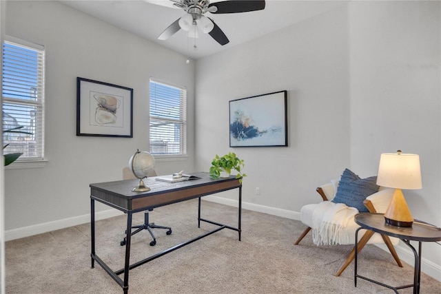 office space featuring light carpet and ceiling fan