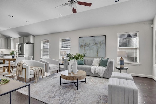 living room featuring ceiling fan, lofted ceiling, dark hardwood / wood-style floors, and a wealth of natural light