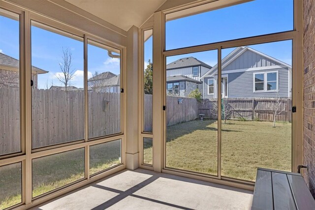 unfurnished sunroom featuring vaulted ceiling