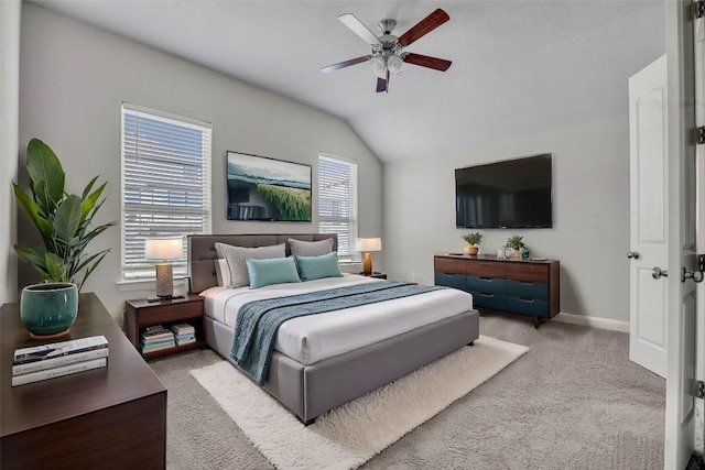 carpeted bedroom featuring vaulted ceiling and ceiling fan