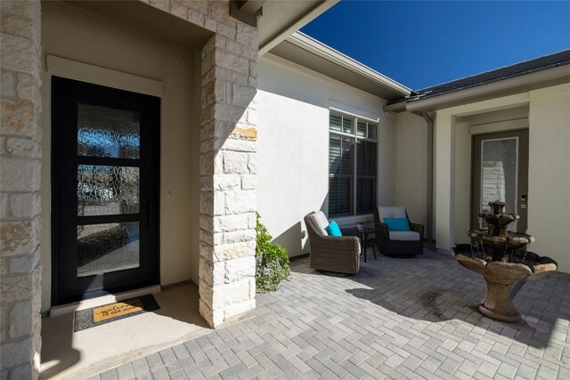 doorway to property with a patio area