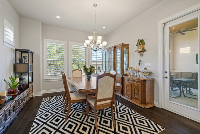 dining room with dark wood-type flooring and an inviting chandelier