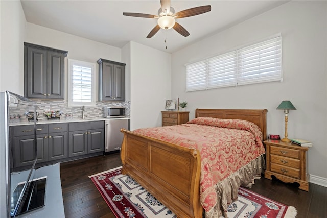 bedroom with sink, dark wood-type flooring, fridge, and ceiling fan