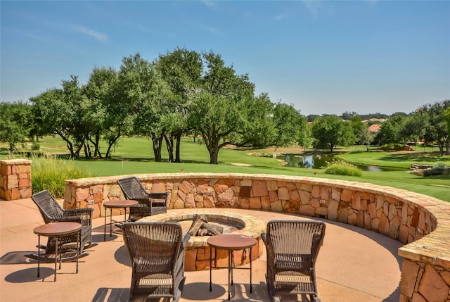 view of patio / terrace featuring a water view and an outdoor fire pit