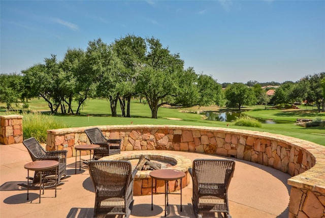 1005 Flint Ridge Trl, Georgetown, TX 78628 - view of patio with a fire pit, a water view, and golf course view