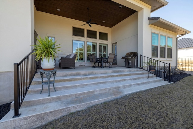 exterior space featuring ceiling fan and a grill