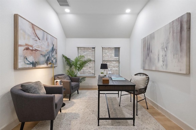 office space featuring light hardwood / wood-style flooring and vaulted ceiling