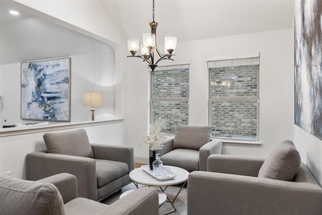 living area featuring an inviting chandelier, vaulted ceiling, and wood-type flooring