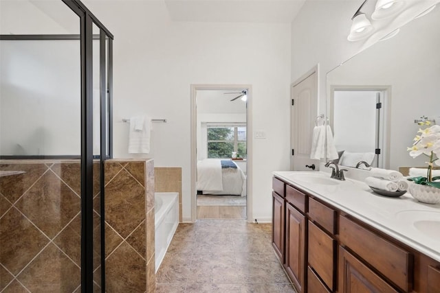 bathroom with vanity and tiled bath