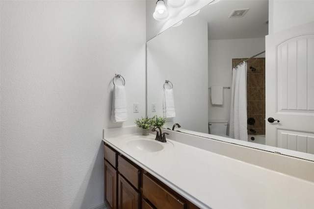 full bathroom with vanity, shower / bath combination with curtain, and toilet