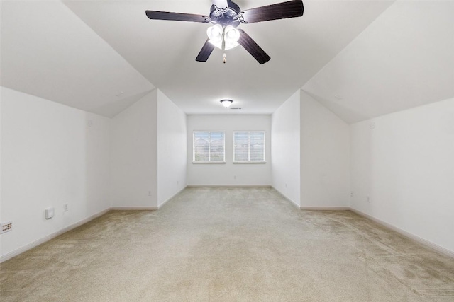 additional living space featuring ceiling fan, vaulted ceiling, and light carpet