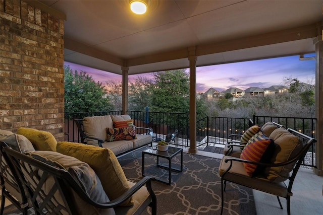 patio terrace at dusk with a balcony and outdoor lounge area