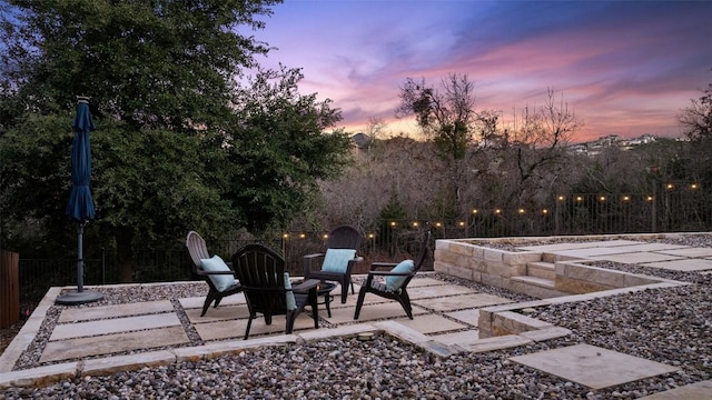 view of patio terrace at dusk