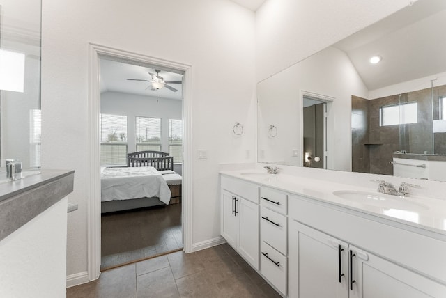 bathroom featuring lofted ceiling, vanity, tiled shower, ceiling fan, and tile patterned floors