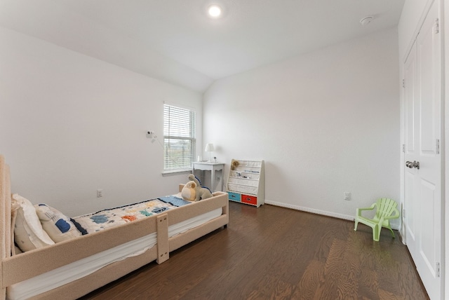 bedroom with dark hardwood / wood-style flooring and vaulted ceiling