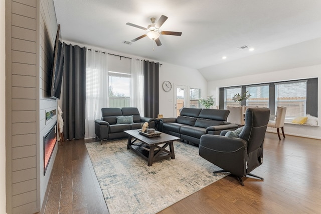 living room featuring lofted ceiling, wood-type flooring, and ceiling fan