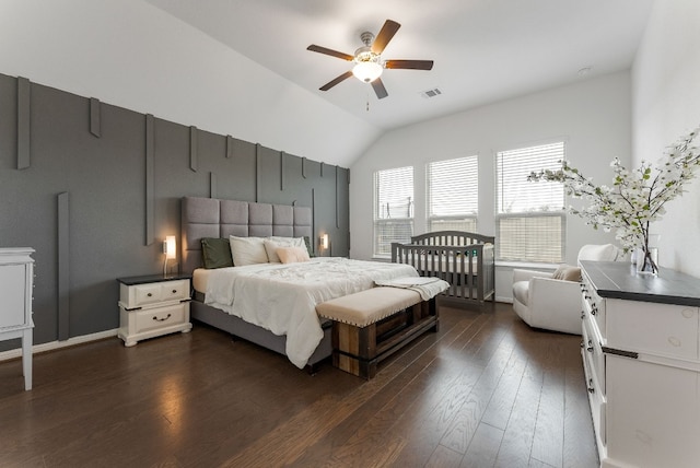 bedroom featuring vaulted ceiling, dark hardwood / wood-style floors, and ceiling fan