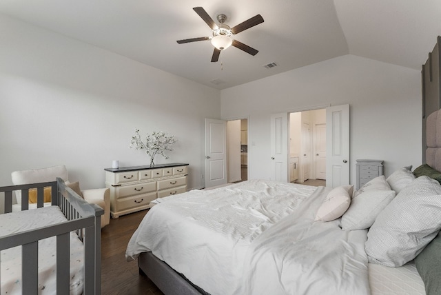 bedroom with dark wood-type flooring, vaulted ceiling, and ceiling fan