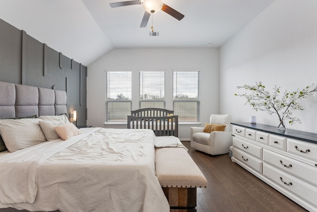 bedroom featuring ceiling fan, dark hardwood / wood-style flooring, and vaulted ceiling