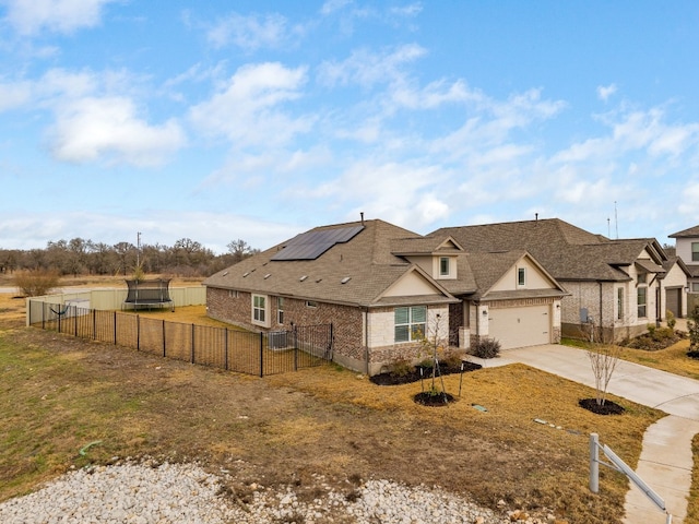 view of front of home featuring a garage and solar panels