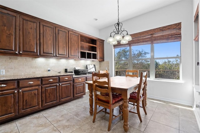 dining space with light tile patterned floors and a chandelier