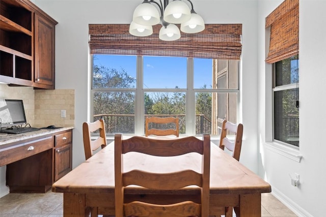 dining space featuring light tile patterned floors and a chandelier