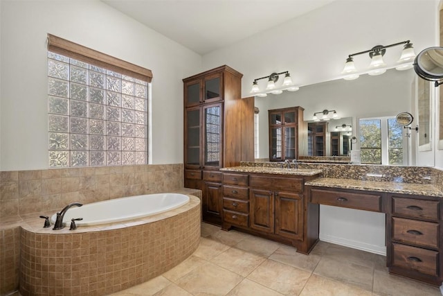 bathroom with vanity, tiled bath, and tile patterned floors