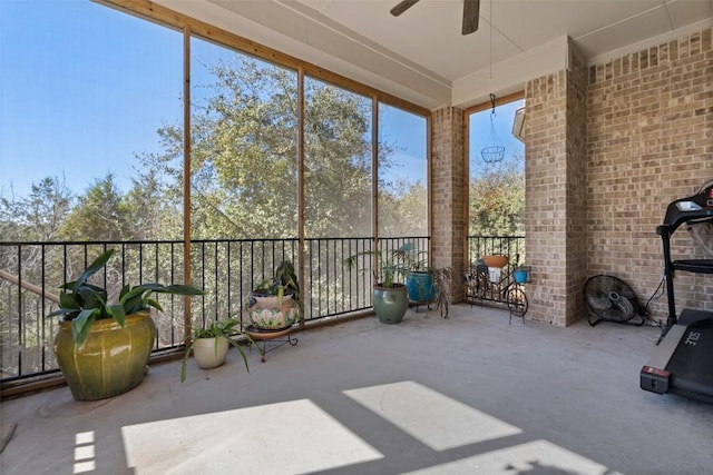 unfurnished sunroom featuring ceiling fan