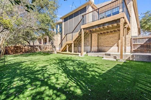 back of house featuring a wooden deck and a lawn