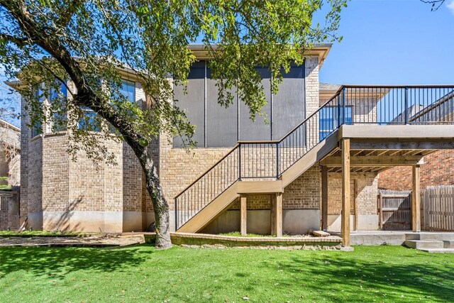172 Mirafield Ln, Austin, TX 78737 - back of house with stairway, a deck, brick siding, and a yard