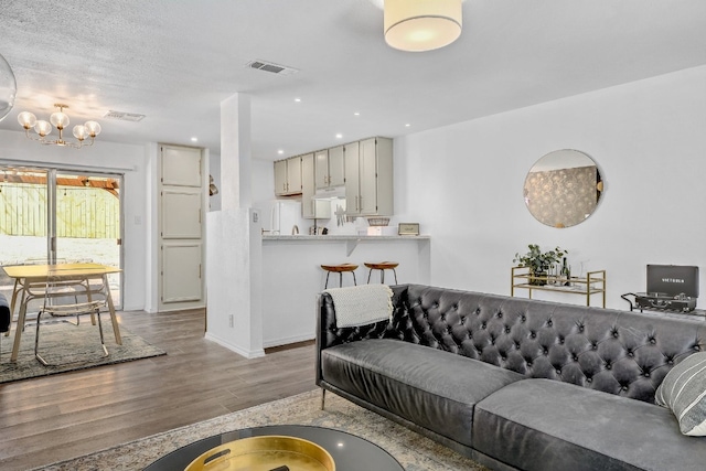 living room featuring a notable chandelier and light wood-type flooring