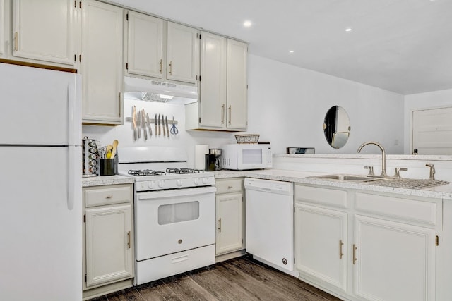 kitchen with sink, dark wood-type flooring, white cabinets, and white appliances