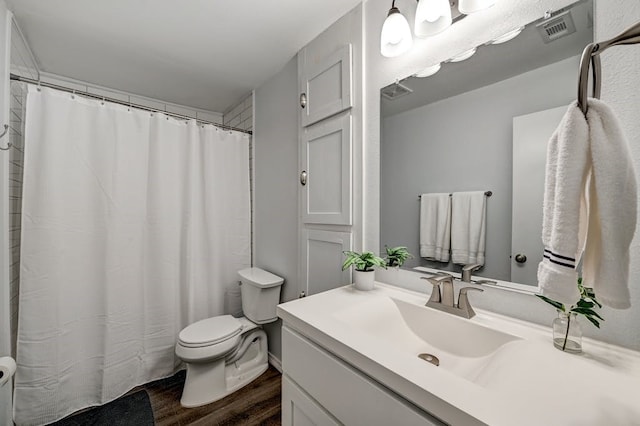 bathroom with vanity, hardwood / wood-style floors, and toilet