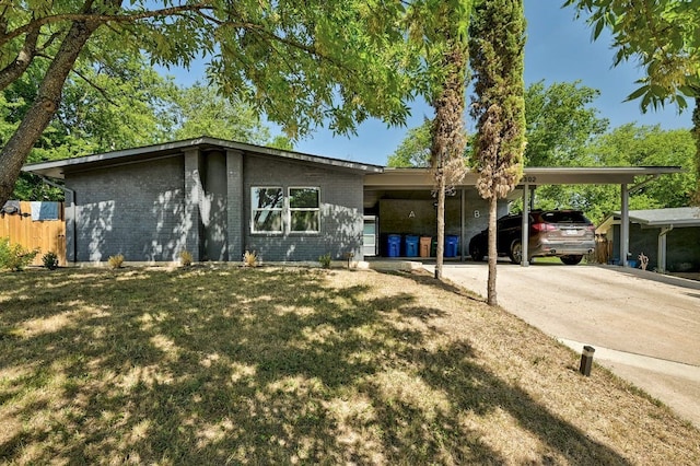 ranch-style home featuring a carport and a front yard