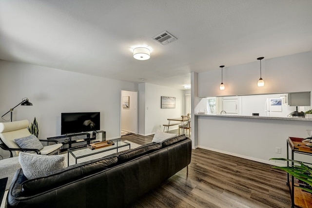 living room with dark hardwood / wood-style flooring